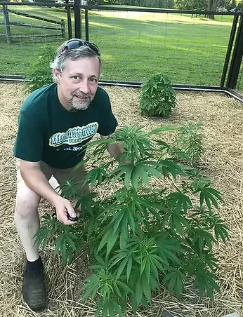 Matt, co-owner of Microgrown Market, tending to hemp plants on their micro-farm in Pennsylvania